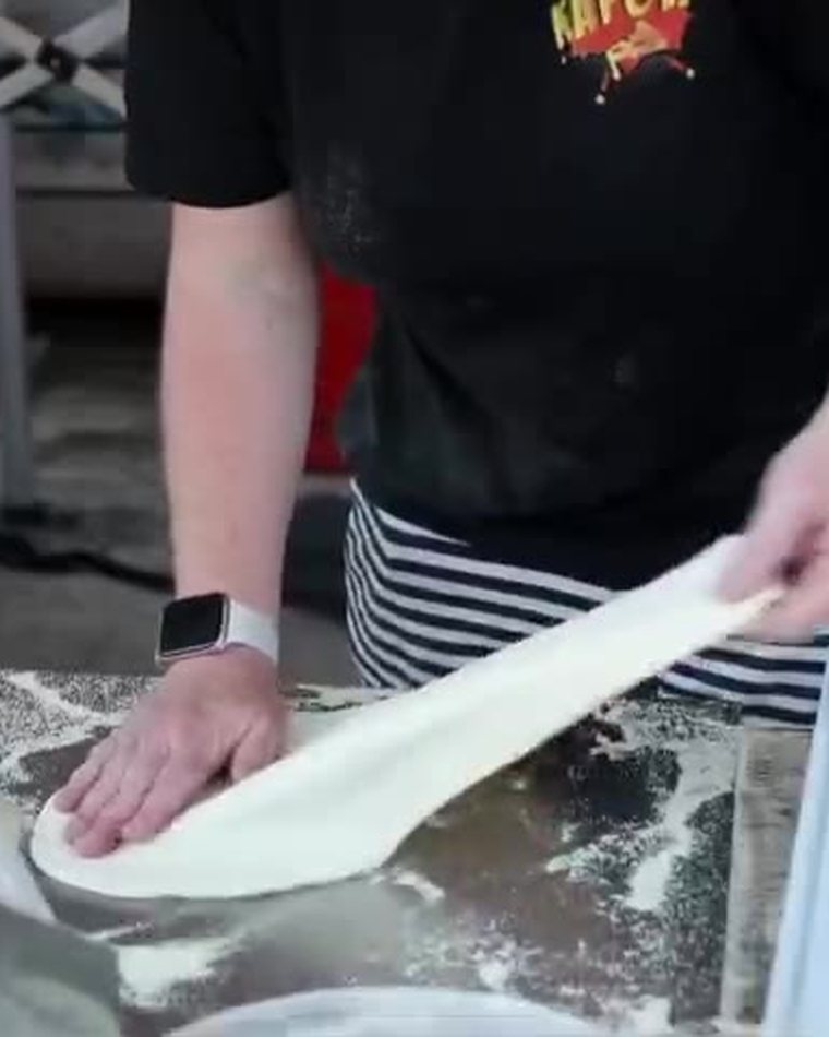 Hand-stretching pizza dough at The Fire Kitchen
